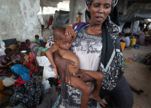 Mulher somali carrega filho subnutrido em um acampamento na capital Mogadício; ONU diz que crise será longa